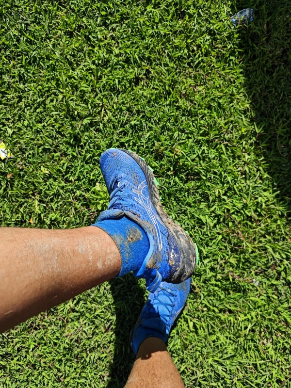 A close up of a person wearing blue shoes.